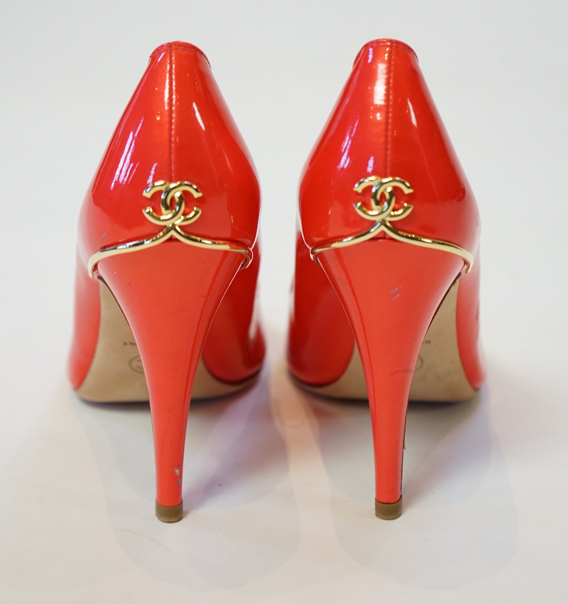 A pair of Chanel lady's metallic coral peep toe patent leather heels, size EU 39.5